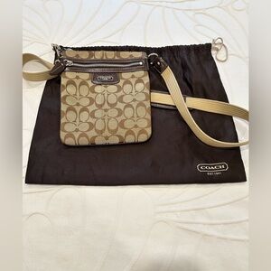 Coach canvas crossbody bag with adjustable strap.